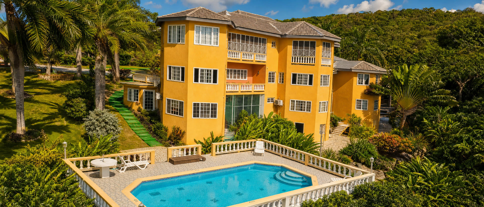 The villa from above in daylight, pool in the foreground