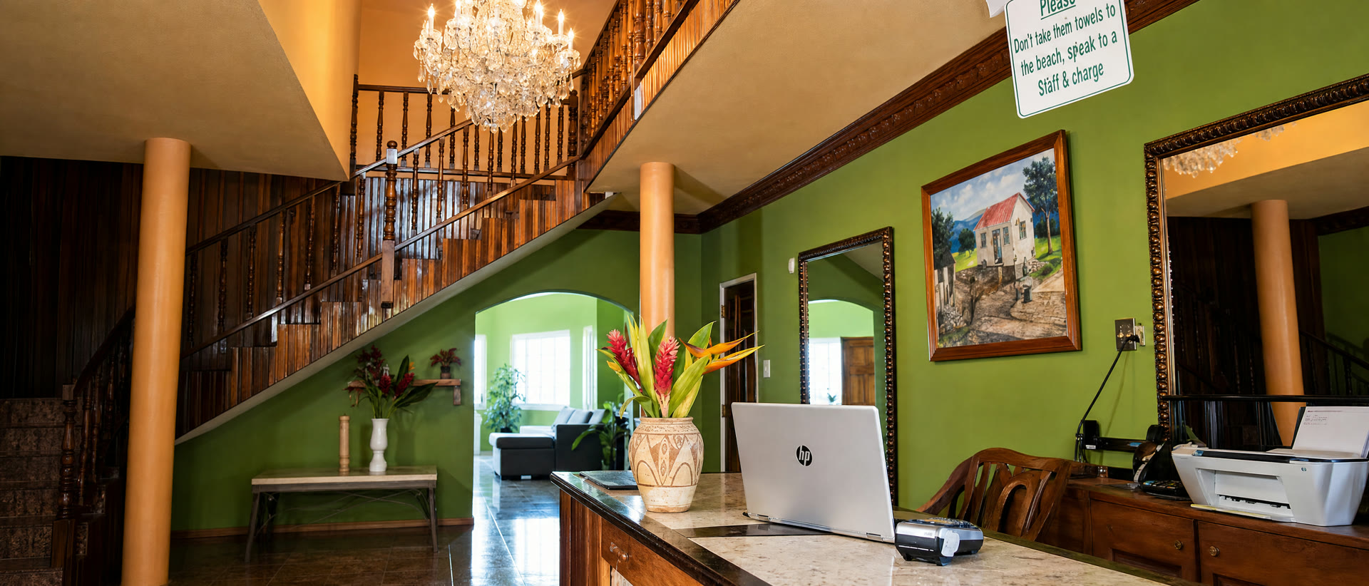 The foyer — chandelier over the curved wooden staircase